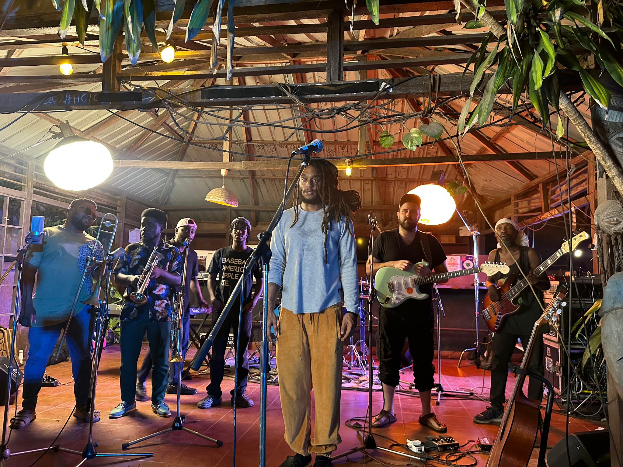 Live band performing with stage microphones and sound equipment